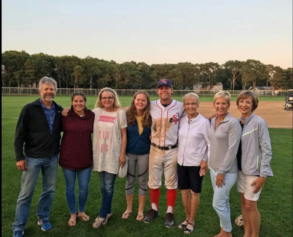 Nico Hoerner family posing for a picture on a baseball field.